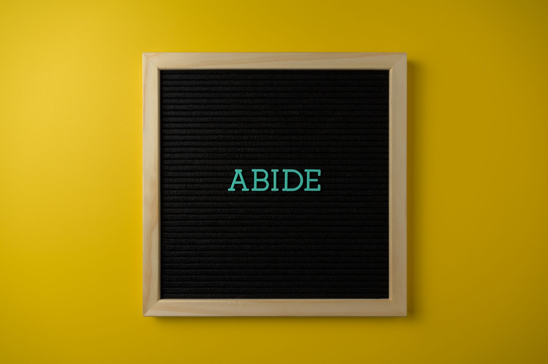 wooden framed text board on yellow background