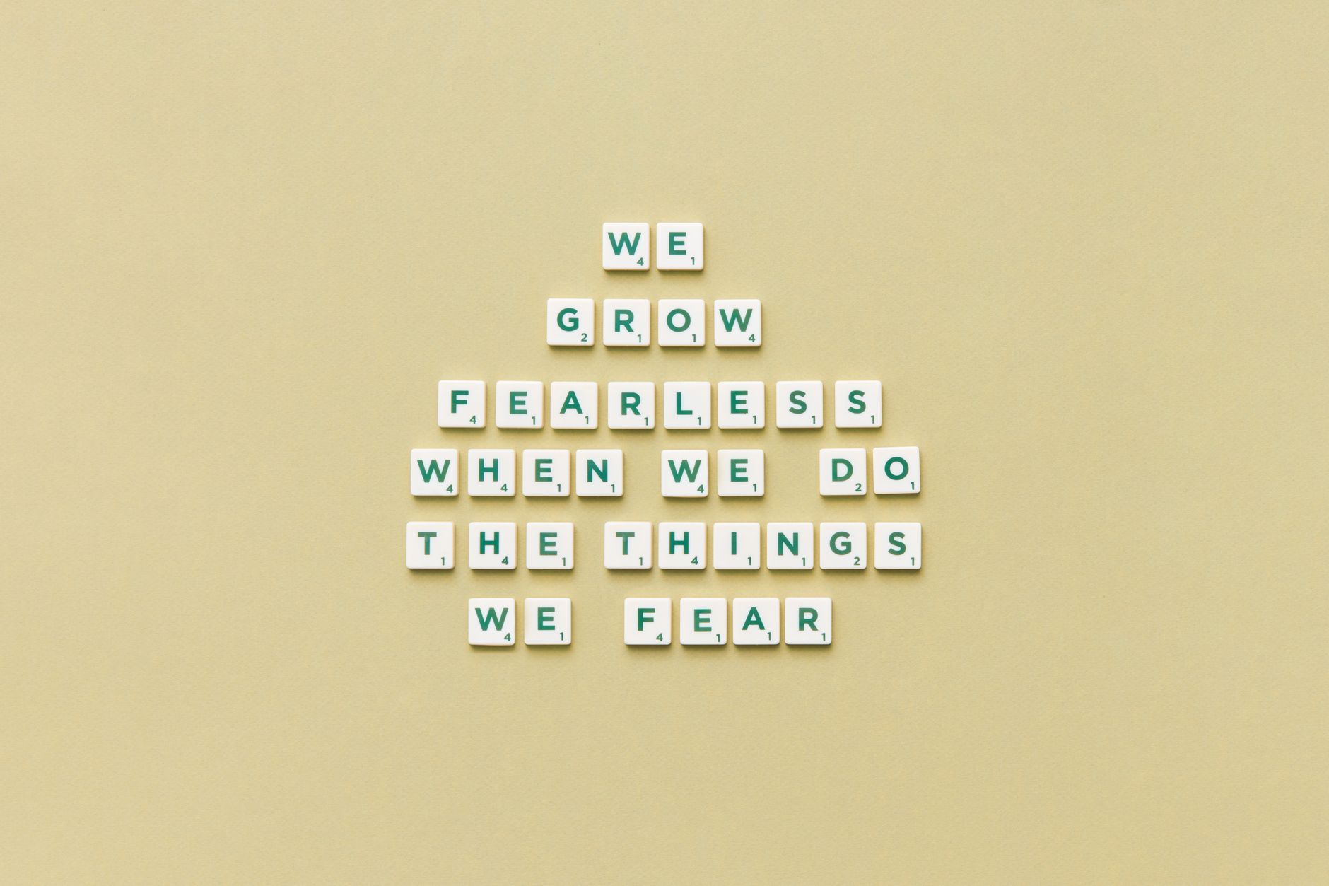 close up of motto from scrabble letters