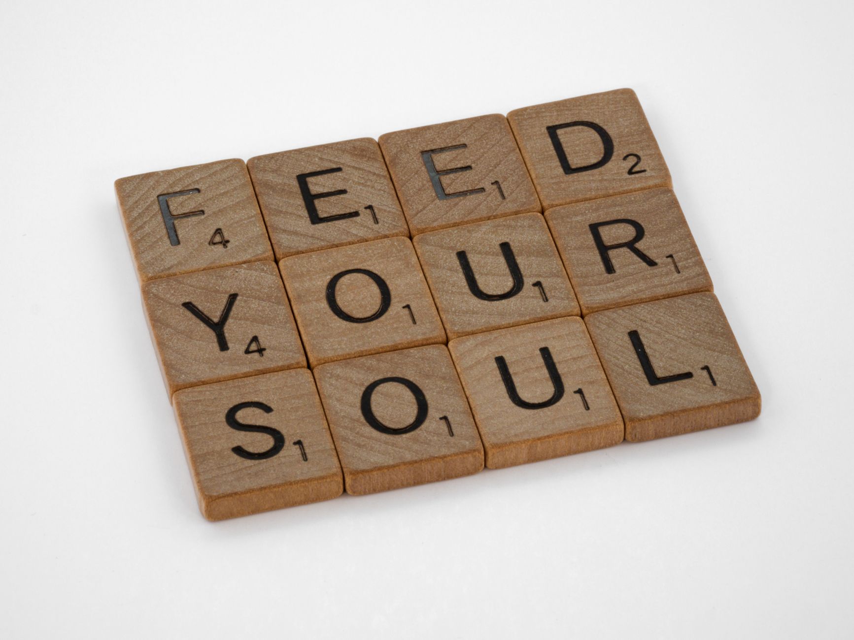 wooden scrabble pieces on white background