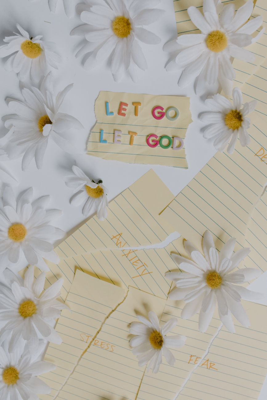 letter cutouts and papers surrounded with flowers